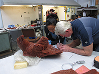Miles Tucker adding finishing touches to the wax rendition of 'The Eagle Has Landed' bronze sculpture prior to casting.
