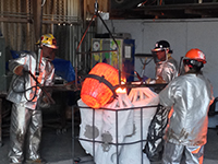 Foundry persons pouring the molten bronze for casting 'The Eagle Has Landed' bronze sculpture by Miles Tucker.